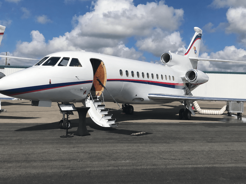 Commercial jet on tarmac with boarding stairs deployed